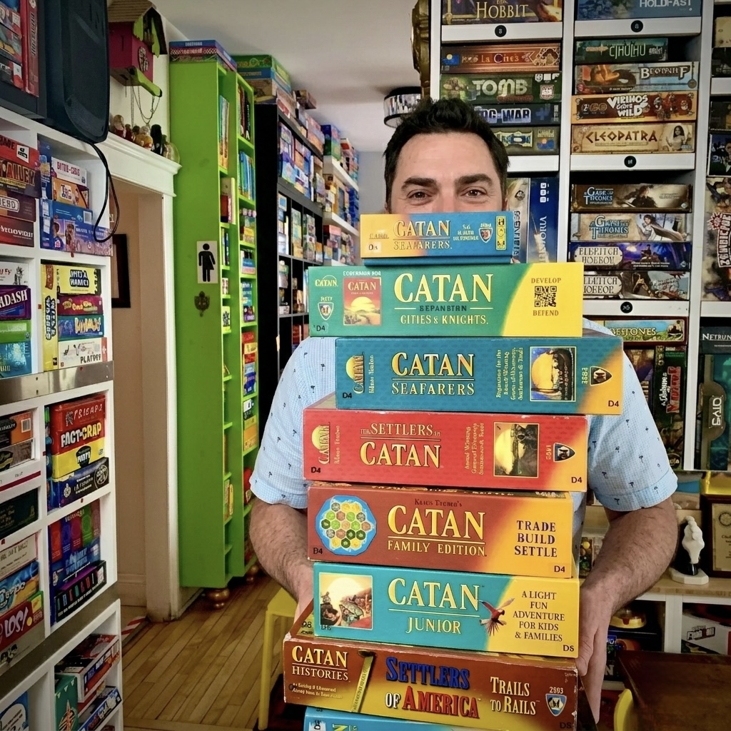 Sébastien Després holding a tower of Catan board games